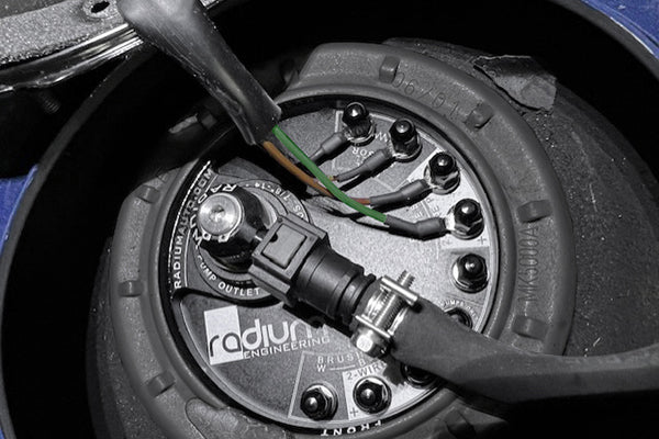 Close-up of a fuel pump with 'radius engineering' branding on a dark background