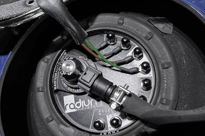 Close-up of a fuel pump with 'radius engineering' branding on a dark background